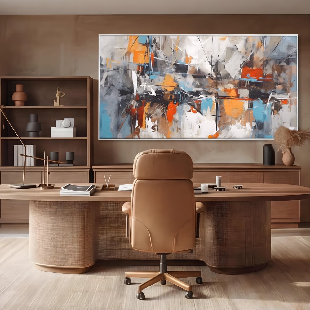 Tablou canvas cu pictura abstracta cu pete portocalii, in rama de aluminiu argintiu, pe perete intr-un birou
